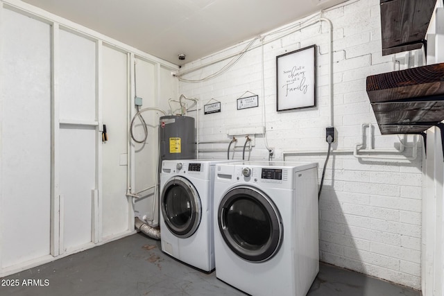 laundry room with water heater and separate washer and dryer