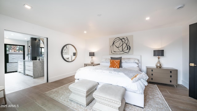 bedroom featuring wood finished floors, baseboards, and recessed lighting