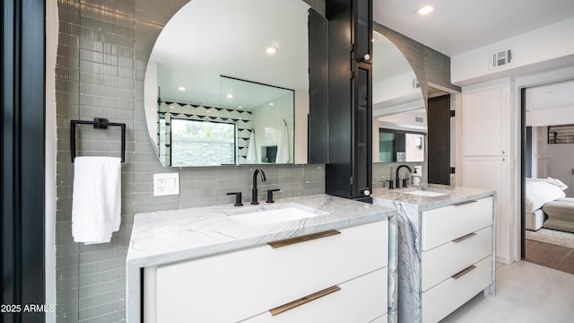 4434 E Camelback Rd Unit 128, Phoenix, AZ 85018 - ensuite bathroom with two vanities and tasteful backsplash