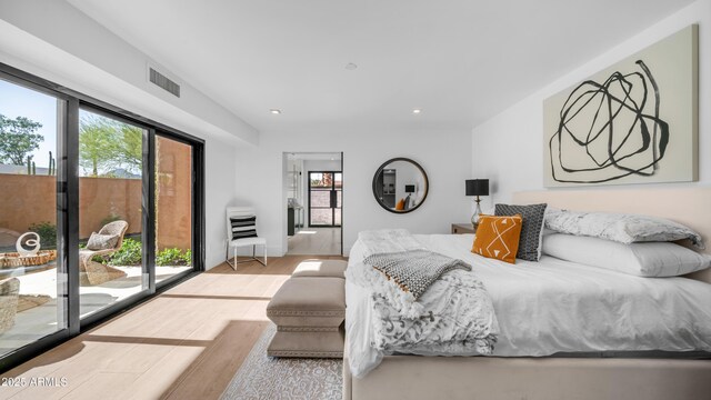 4434 E Camelback Rd Unit 128, Phoenix, AZ 85018 - bedroom featuring access to exterior, wood finished floors, and recessed lighting