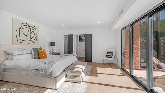 4434 E Camelback Rd Unit 128, Phoenix, AZ 85018 - bedroom featuring wood finished floors, recessed lighting, and access to exterior