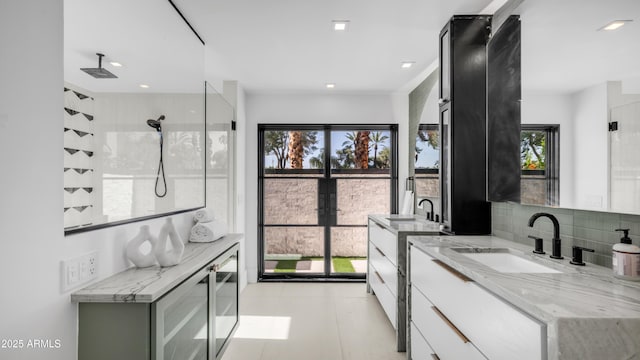 4434 E Camelback Rd Unit 128, Phoenix, AZ 85018 - full bathroom with vanity, a tile shower, and backsplash
