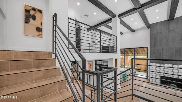 4434 E Camelback Rd Unit 128, Phoenix, AZ 85018 - stairway featuring beamed ceiling, a towering ceiling, and recessed lighting