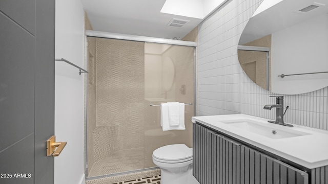 4434 E Camelback Rd Unit 128, Phoenix, AZ 85018 - bathroom with vanity, toilet, a stall shower, and tile patterned flooring