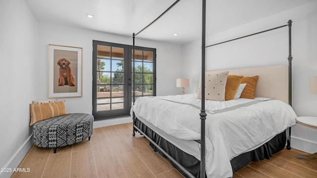 4434 E Camelback Rd Unit 128, Phoenix, AZ 85018 - bedroom with access to outside, french doors, wood finished floors, baseboards, and recessed lighting