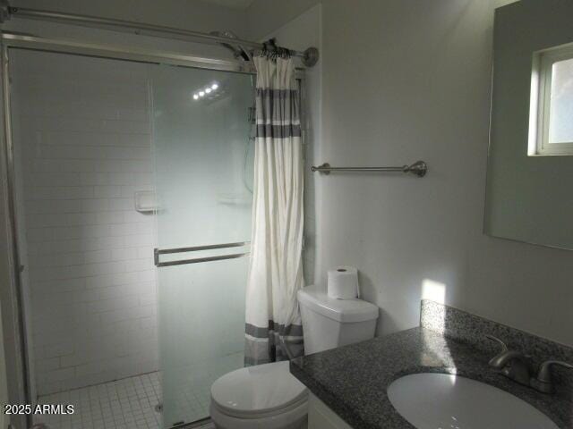 bathroom featuring toilet, vanity, and a shower with curtain