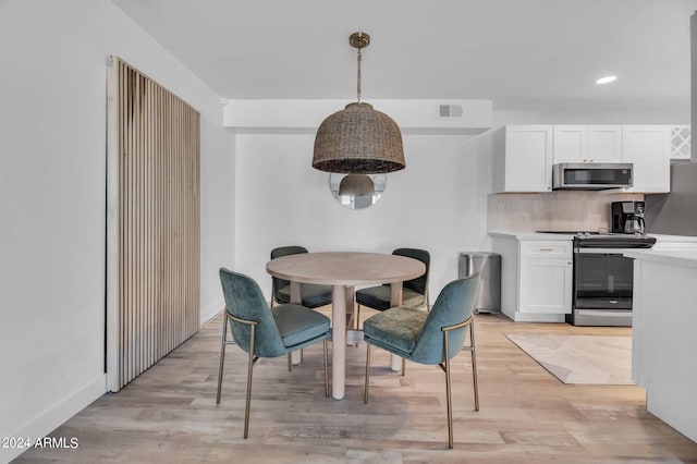 dining space with light hardwood / wood-style flooring