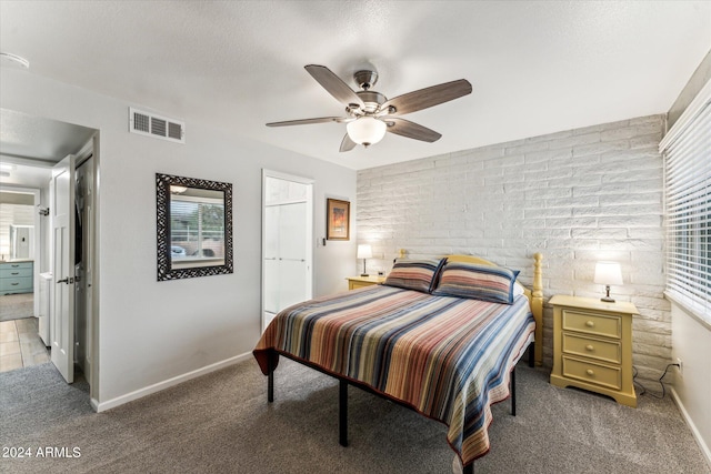 carpeted bedroom featuring a textured ceiling and ceiling fan