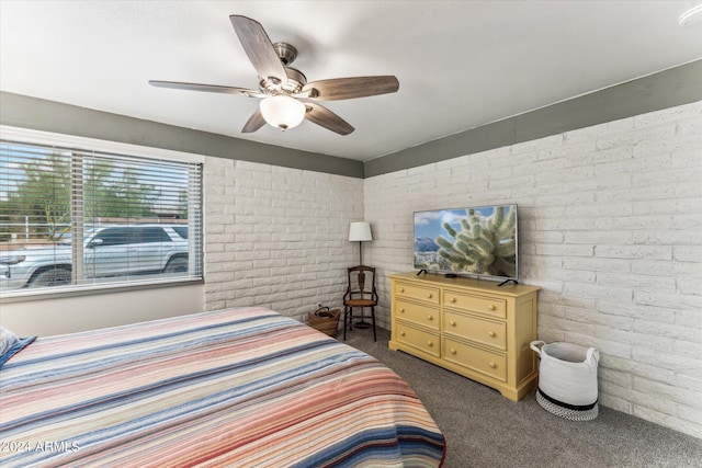 carpeted bedroom with brick wall and ceiling fan