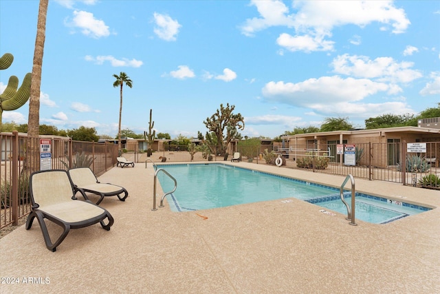 view of swimming pool with a patio area