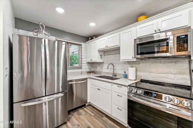 kitchen with sink, white cabinets, and stainless steel appliances