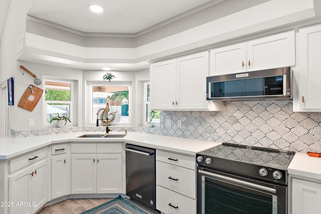 10838 N 10th St, Phoenix, AZ 85020 - kitchen with range with electric cooktop, dishwasher, stainless steel microwave, a sink, and white cabinets