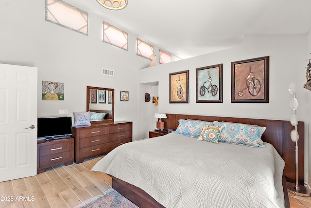 10838 N 10th St, Phoenix, AZ 85020 - bedroom with light wood-type flooring and high vaulted ceiling