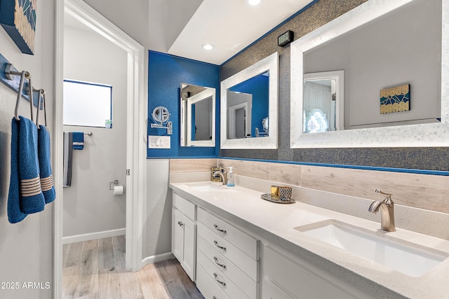10838 N 10th St, Phoenix, AZ 85020 - bathroom with wood finished floors, double vanity, baseboards, and recessed lighting