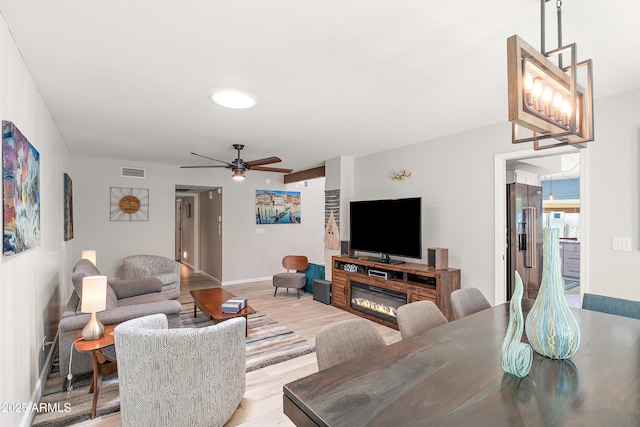 10838 N 10th St, Phoenix, AZ 85020 - living area featuring light wood-type flooring, a ceiling fan, and baseboards