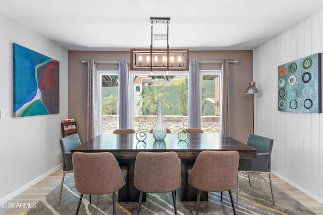 10838 N 10th St, Phoenix, AZ 85020 - dining space featuring wood finished floors, a chandelier, baseboards, and wooden walls