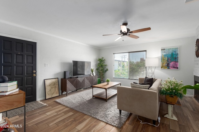 living room with ceiling fan, crown molding, and hardwood / wood-style flooring