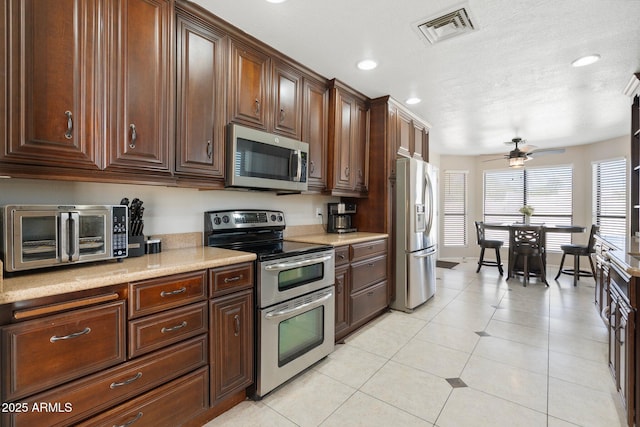 7503 W Julie Dr, Glendale, AZ 85308 - kitchen featuring appliances with stainless steel finishes, light countertops, ceiling fan, recessed lighting, and light tile patterned floors