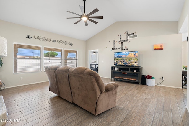 7503 W Julie Dr, Glendale, AZ 85308 - living room with ceiling fan, wood finished floors, high vaulted ceiling, and baseboards
