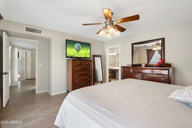 7503 W Julie Dr, Glendale, AZ 85308 - bedroom featuring light wood-style floors, baseboards, ensuite bathroom, and a ceiling fan