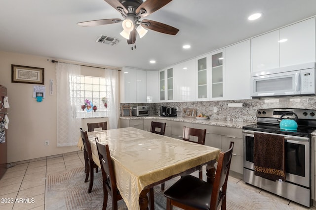 kitchen with white cabinets, ceiling fan, stainless steel electric range oven, and light stone counters