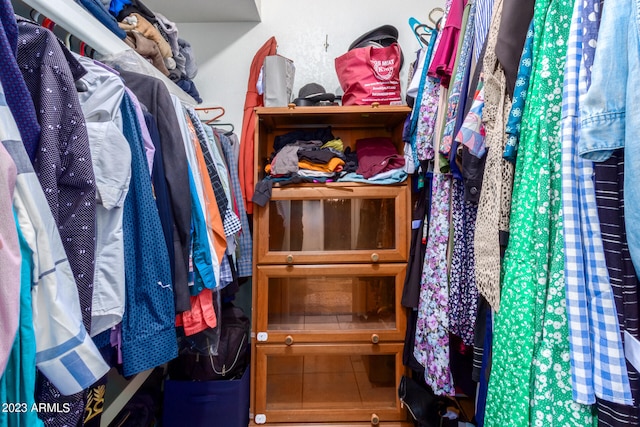 walk in closet featuring tile flooring