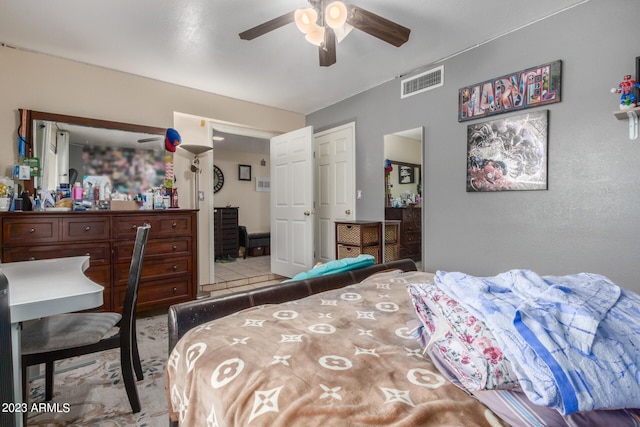 tiled bedroom with ceiling fan