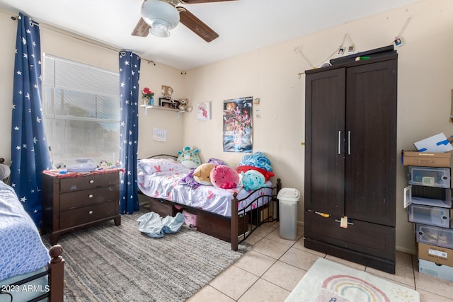 tiled bedroom with ceiling fan