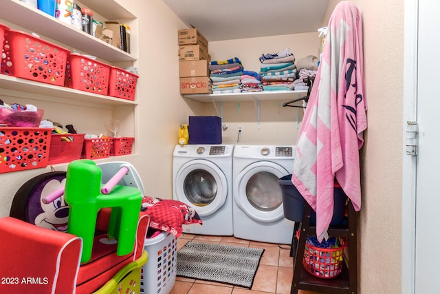 laundry area with independent washer and dryer and light tile floors