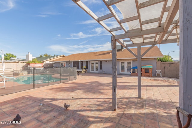 view of terrace with a fenced in pool, a pergola, and french doors