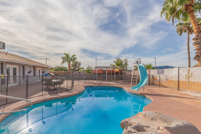 view of swimming pool featuring a patio and a water slide