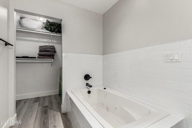 7440 E Hubbell St, Scottsdale, AZ 85257 - bathroom featuring wood finished floors and a jetted tub
