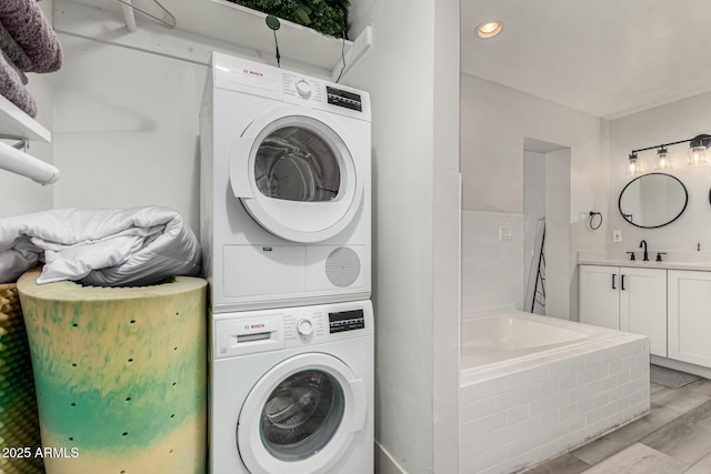 7440 E Hubbell St, Scottsdale, AZ 85257 - laundry room with stacked washer / drying machine, light wood-type flooring, and recessed lighting