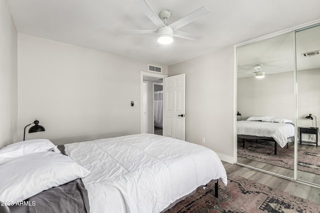 7440 E Hubbell St, Scottsdale, AZ 85257 - bedroom with wood finished floors, a closet, and ceiling fan