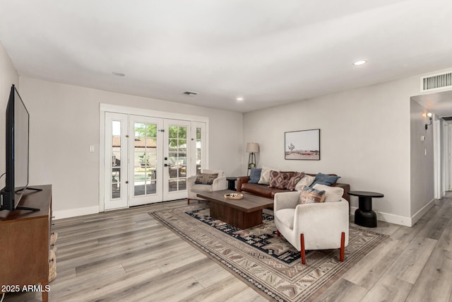7440 E Hubbell St, Scottsdale, AZ 85257 - living room featuring light wood-style floors, french doors, and recessed lighting