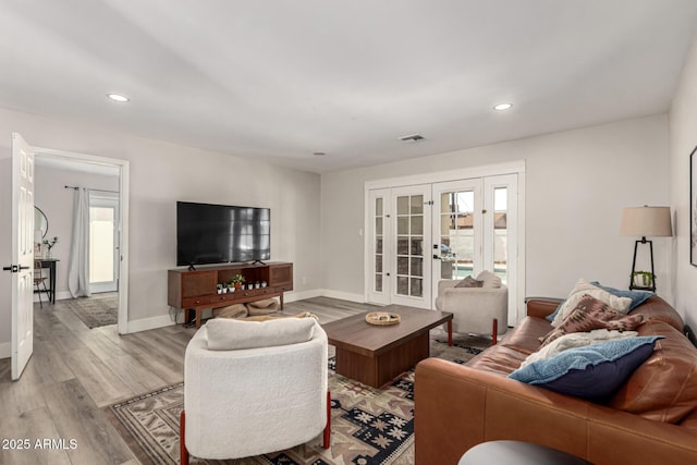 7440 E Hubbell St, Scottsdale, AZ 85257 - living area featuring french doors, light wood-style floors, and recessed lighting