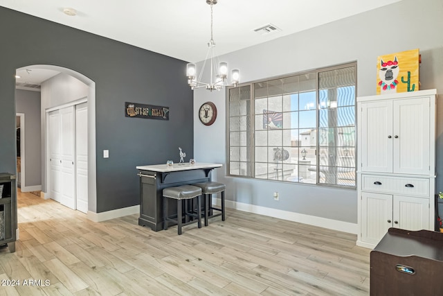 dining space featuring a chandelier and light hardwood / wood-style floors