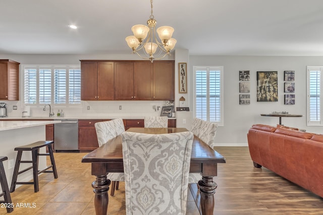 dining area with sink, a chandelier, and a healthy amount of sunlight