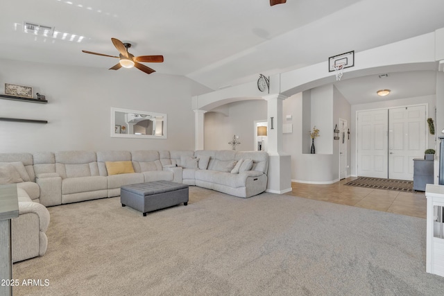 living room featuring lofted ceiling, light tile patterned flooring, ceiling fan, and ornate columns