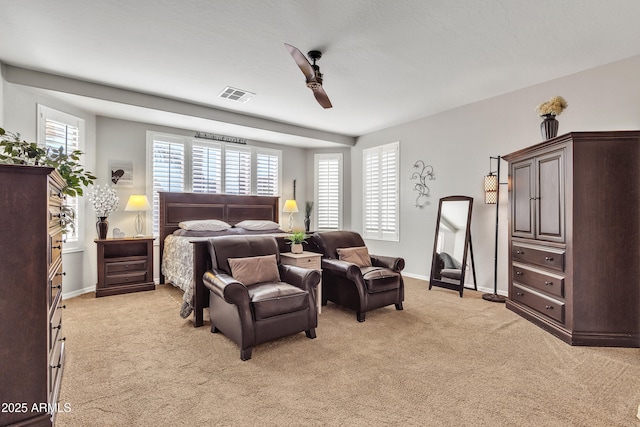 bedroom with ceiling fan and light colored carpet