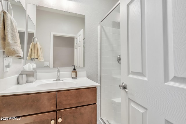 bathroom featuring walk in shower and vanity