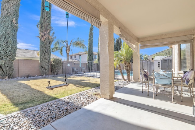 view of patio featuring a storage shed and a swimming pool