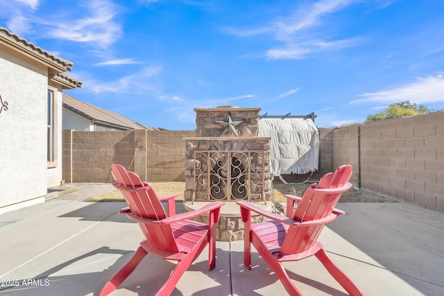 view of patio / terrace featuring an outdoor stone fireplace