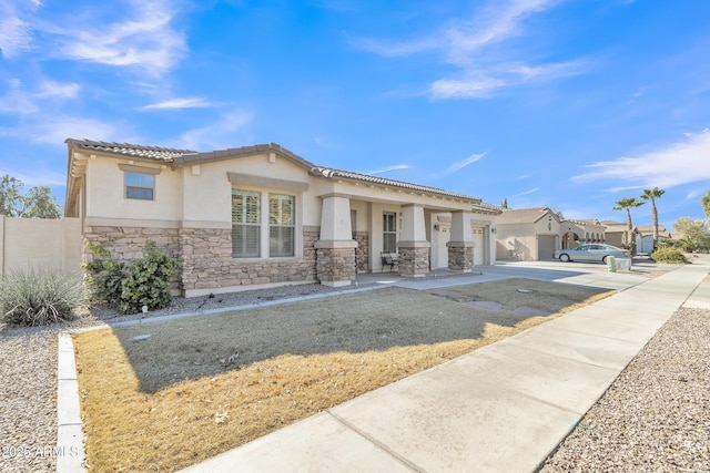 view of front of property with a garage and a front lawn