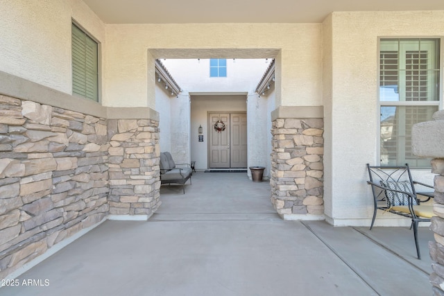 entrance to property featuring a patio