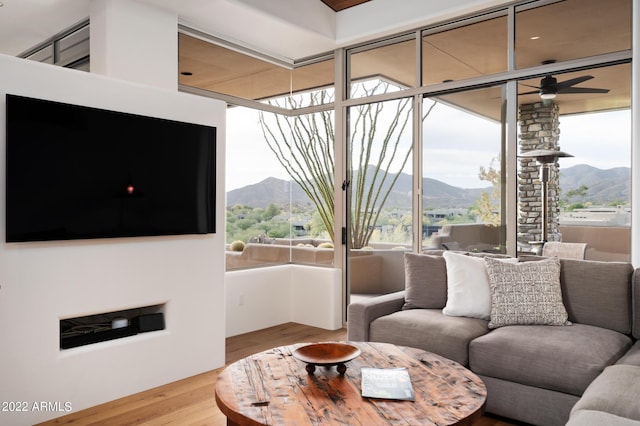 living room featuring hardwood / wood-style flooring and ceiling fan