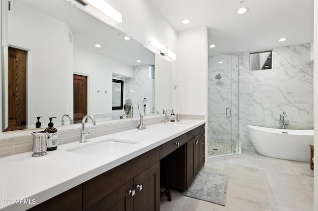 bathroom featuring vanity and separate shower and tub