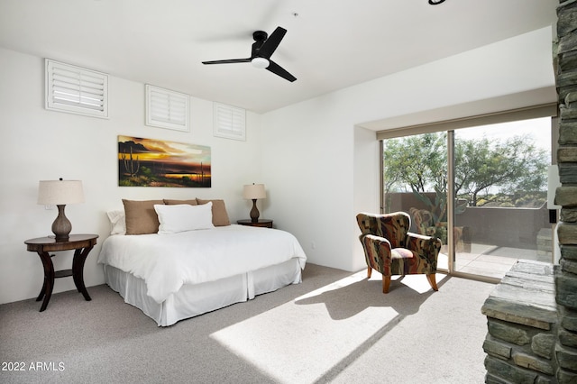 carpeted bedroom featuring ceiling fan and access to exterior