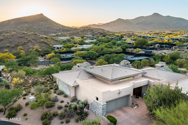 aerial view at dusk featuring a mountain view