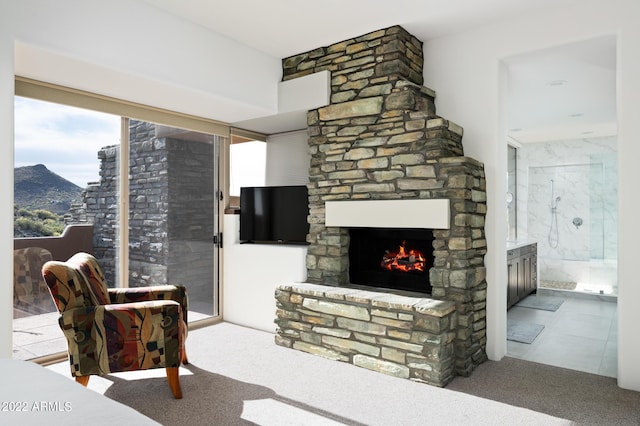 carpeted living room with a mountain view and a fireplace